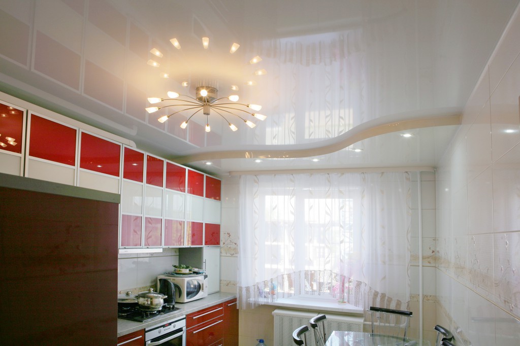 White glossy two-level suspended ceiling in the kitchen