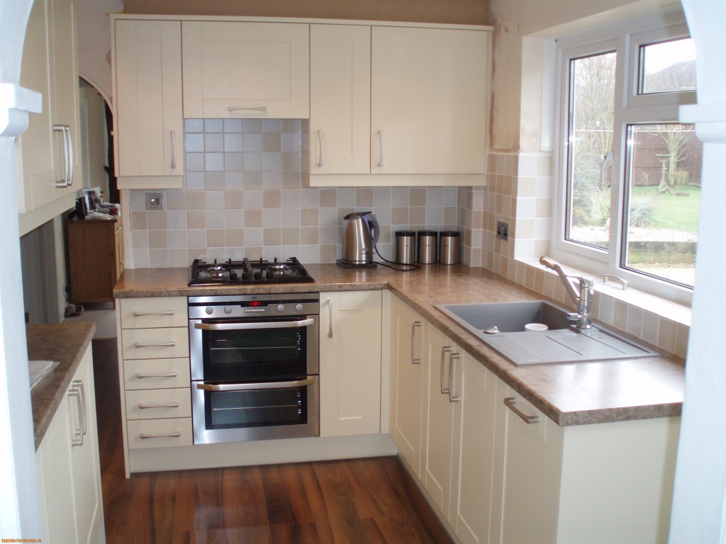 Sink in the bright interior of the kitchen under the window