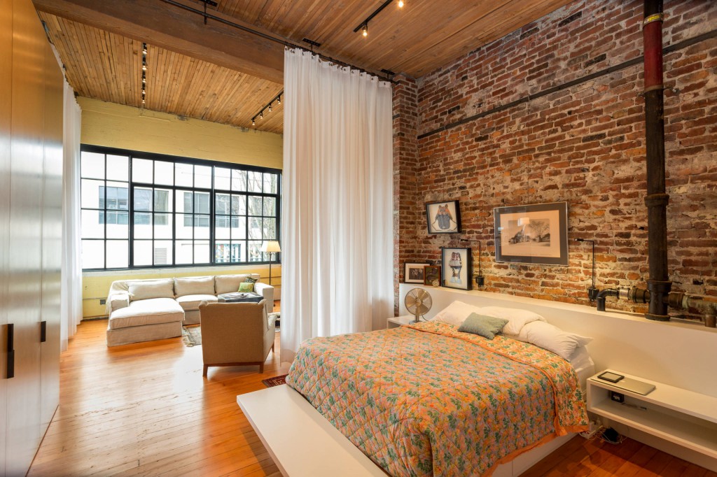 Loft-style bedroom with brick walls