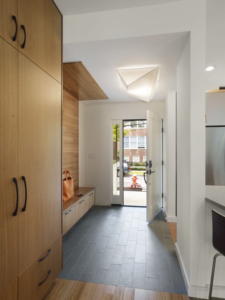 White entrance hall with wooden decor