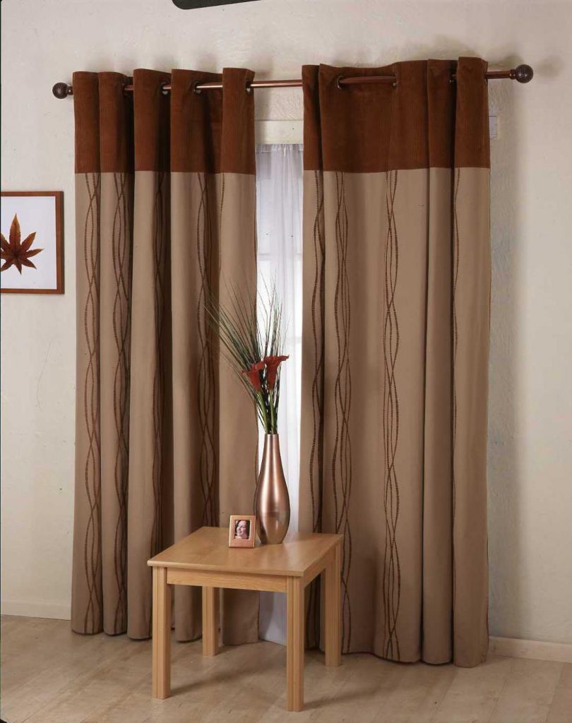 Monochrome brown curtains on the grommets in the interior of the living room