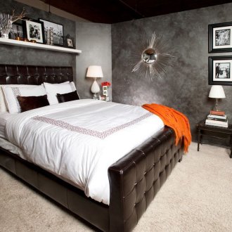 Black leather bed in a black and white bedroom