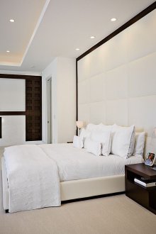 White leather bed and leather trim wall