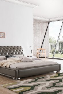 Gray leather bed with curved headboard