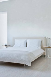 White and beige bedroom in the style of minimalism.