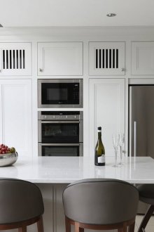 Weiße Küche im modernen Stil mit einer Insel