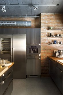 Metal kitchen with island and loft-style wooden worktops