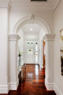 Spotlights in a white corridor with high ceilings