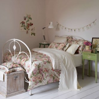 Wooden and wrought iron furniture in a shabby chic bedroom
