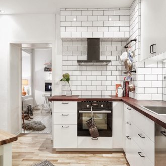 White tile and wooden countertop in the kitchen