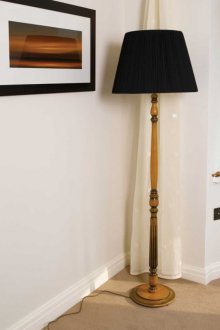 Подова лампа върху дървен крак в интериора