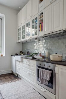 Brown floor in a white kitchen