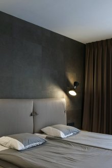 Black wall in a white and gray bedroom