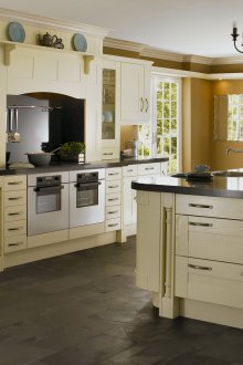 Beige and black kitchen with an island in a private house