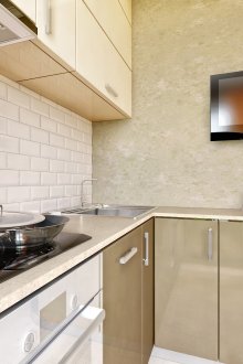 Gray and white glossy kitchen set in the interior