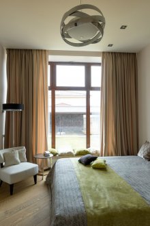 Olive accents in a brown and gray bedroom