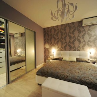 White and brown bedroom with fitted wardrobe