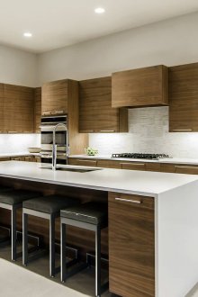 Просторна кафява и бяла кухня с остров