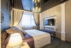 Classic chandelier with black stretch ceiling in the bedroom