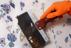 The process of removing old wallpaper with a spatula