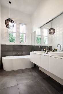 Black chandelier in a modern black and white bathroom
