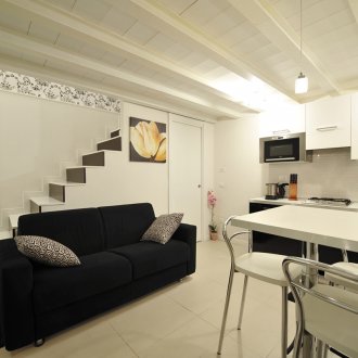 Черен диван в светла кухня