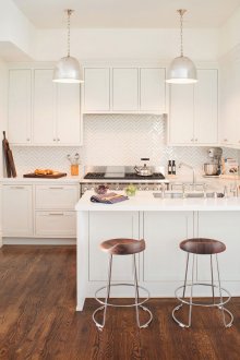 Small bright kitchen with wooden parquet and chairs