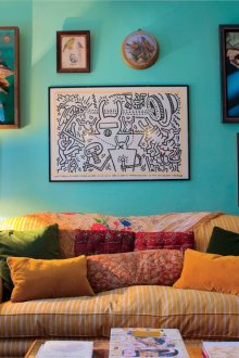 Small boho style living room with emerald walls