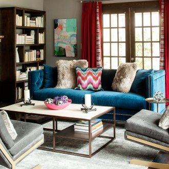 Emphasis on a blue sofa in a boho style interior
