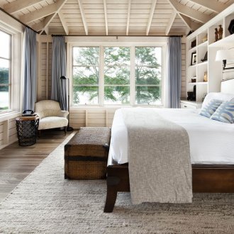 Scandinavian-style bedroom with large windows
