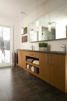 Bathroom with wooden drawers and a transparent shower