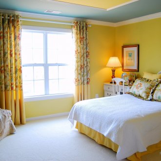 Yellow walls in a spacious bedroom