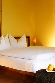 Yellow wallpaper in a small bedroom