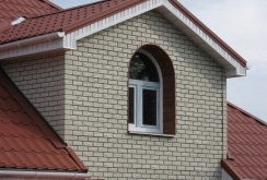 White siding under a brick