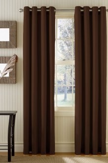 Brown blackout curtains on grommets in a bright interior