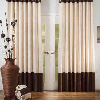 Brown-beige curtains on the grommets in the living room interior