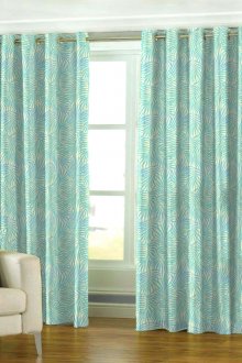 Bright turquoise curtains on the grommets in the room