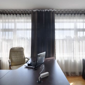 Black curtains on the grommets and white tulle in the study