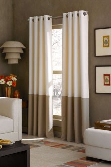 Beige and blackout curtains on grommets in the living room
