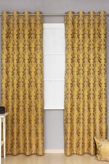 Golden curtains on grommets with a pattern