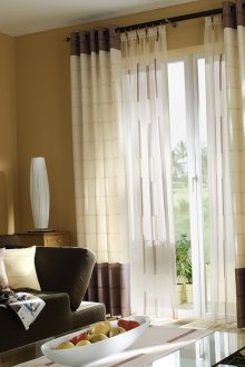 The combination of tulle and blackout curtains on the grommets in the living room