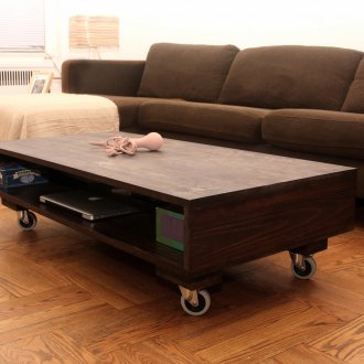 Wooden coffee table on casters with a shelf