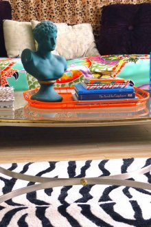 Creamy golden coffee table made of metal and glass in a bright interior