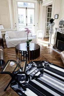 Round coffee table with mirrored panels and a coffee table made of metal and glass in the living room