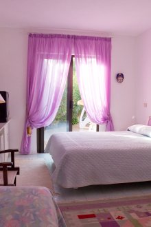 밝은 라일락 커튼이 있는 침실