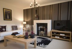 White and dark striped wallpaper in the living room interior.