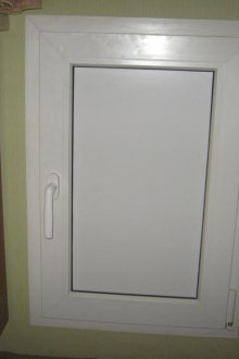 Fridge under the window with door
