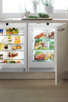 The refrigerator under the window is small