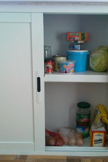 Fridge under a window in a niche