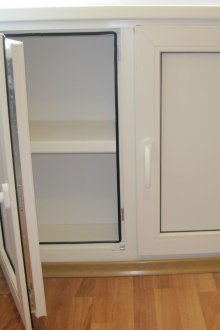 Plastic refrigerator under the window